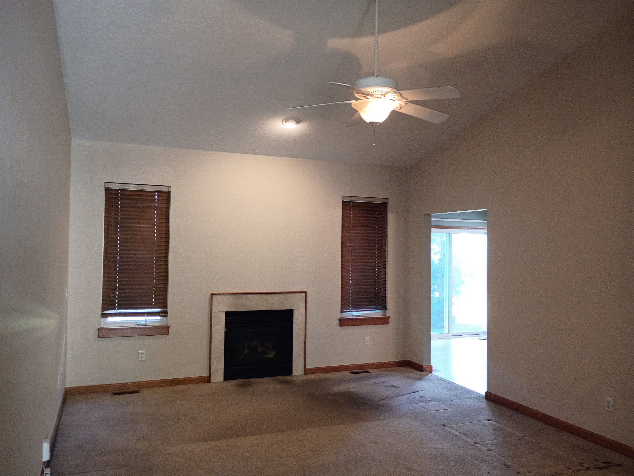 Same living room repainted in Natural Linen with clean white ceiling