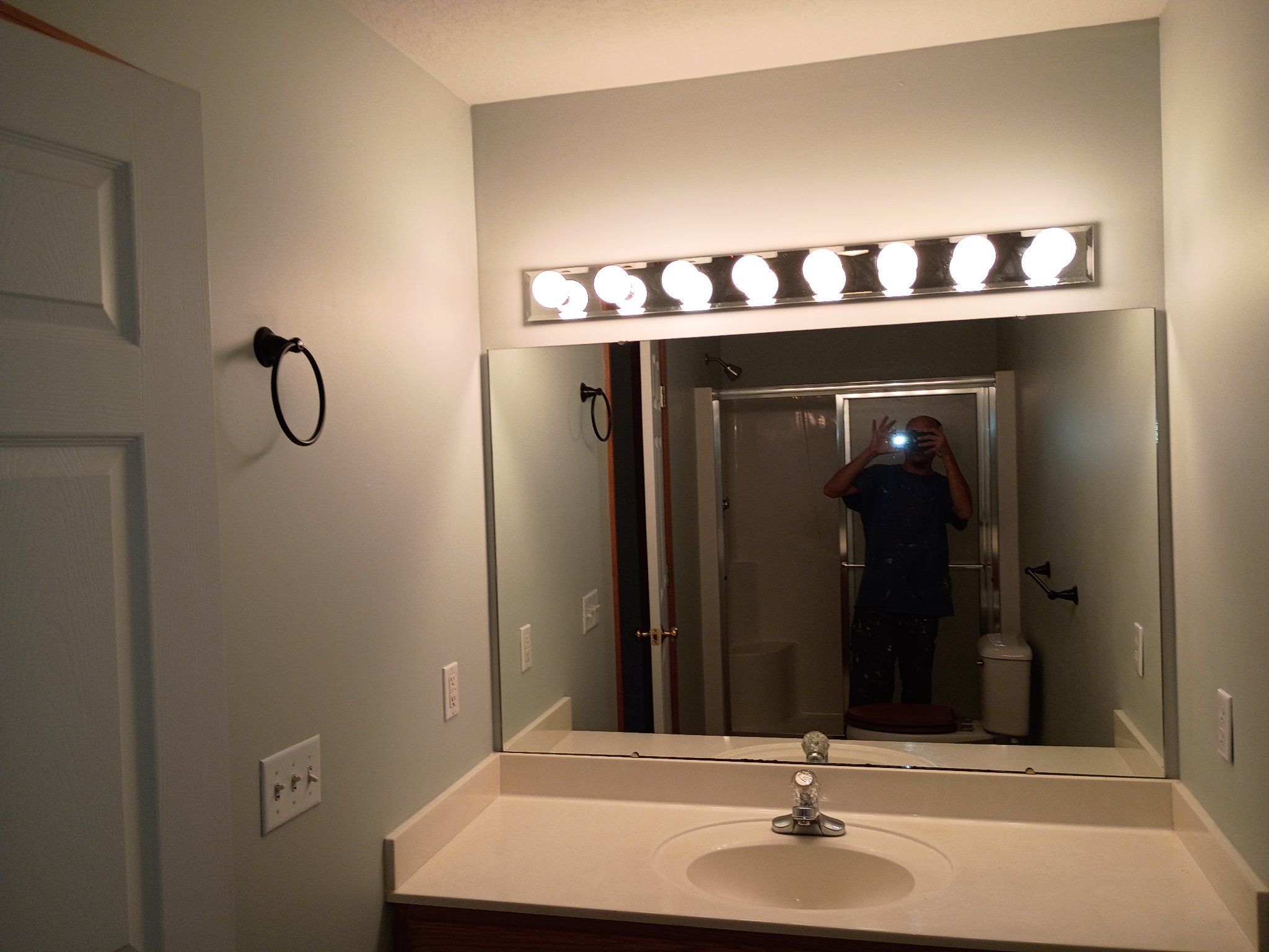 Bathroom repainted in Sea Salt with wide vanity mirror