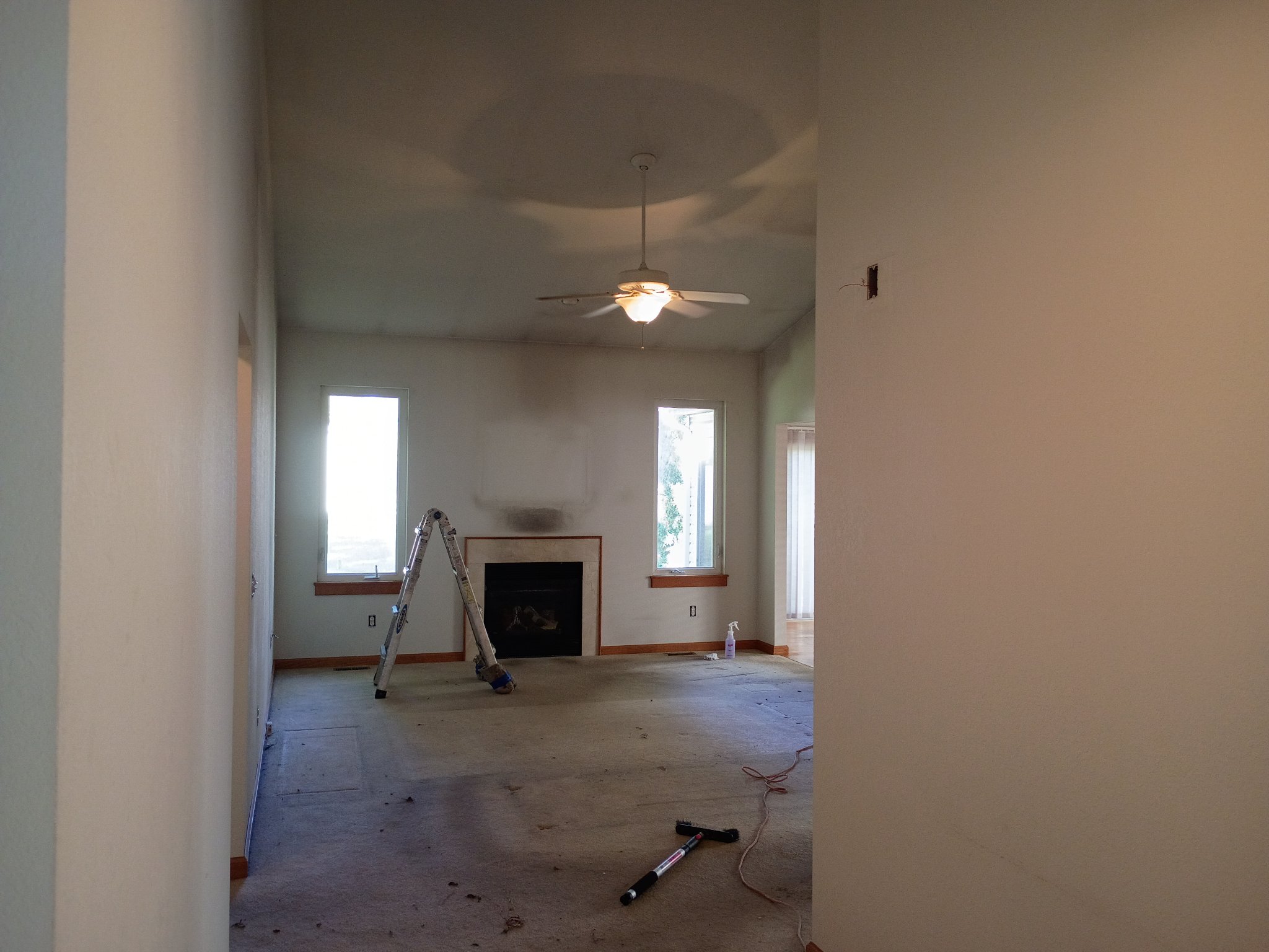 Living room with soot-stained walls and ceiling before repaint, Holland Ohio